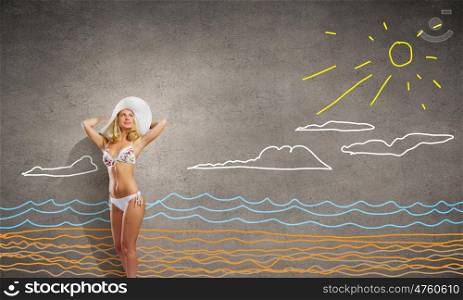 Summer vacation. Pretty girl in white bikini and hat on summer beach
