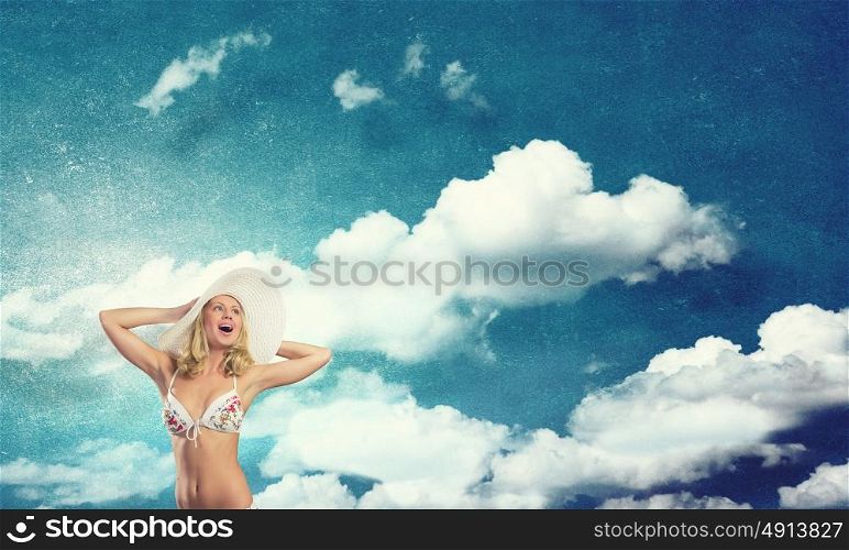 Summer vacation. Pretty girl in white bikini and hat on summer beach