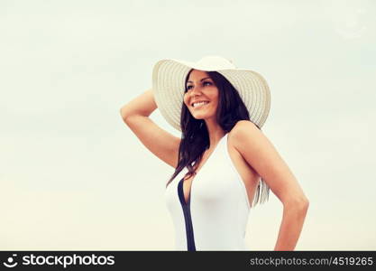 summer vacation, tourism, travel, holidays and people concept -face of happy young woman on beach