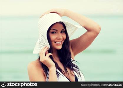 summer vacation, tourism, travel, holidays and people concept -face of happy young woman on beach