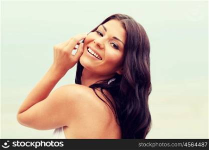 summer vacation, tourism, travel, holidays and people concept -face of happy young woman on beach. happy young woman on beach