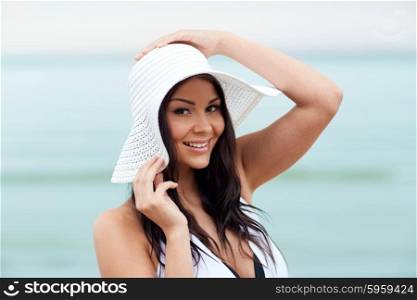 summer vacation, tourism, travel, holidays and people concept -face of happy young woman on beach