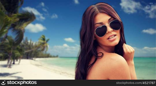 summer vacation, tourism, travel, holidays and people concept - face of young woman with sunglasses over tropical beach with palms background