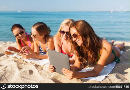 summer vacation, travel, technology and people concept - group of smiling women in sunglasses with tablet pc computers lying on beach