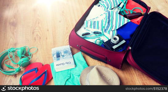 summer vacation, travel, tourism and objects concept - close up of travel bag with clothes and stuff. close up of travel bag with clothes and stuff