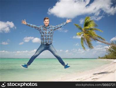 summer vacation, travel, tourism, freedom and people concept - smiling young man jumping in air over tropical beach background