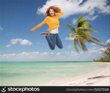 summer vacation, travel, tourism, freedom and people concept - smiling young woman jumping in air over tropical beach background