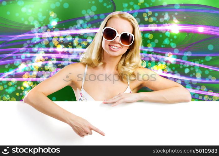 Summer vacation. Young attractive blond in bikini holding blank banner