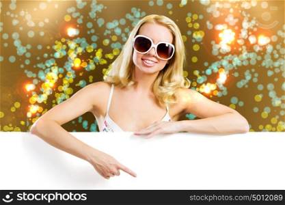 Summer vacation. Young attractive blond in bikini holding blank banner
