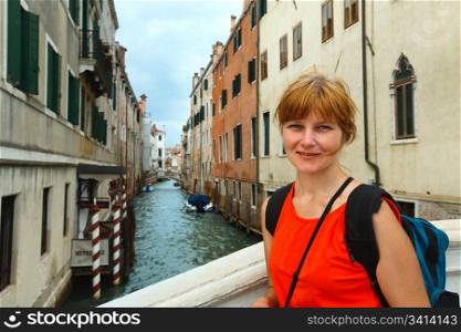 Summer venetian view and woman - tourist (Venice, Italy)