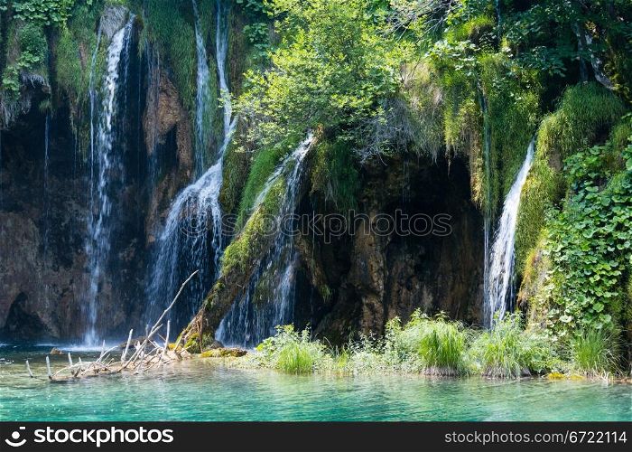 Summer view of beautiful waterfall and grotto (Plitvice Lakes National Park, Croatia)