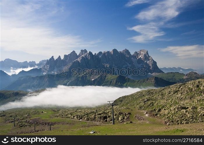 summer view of dolomites mountain with cableway near San Pellegrino pass, Trentino, Italy. On the background Pale San Martino mountain.