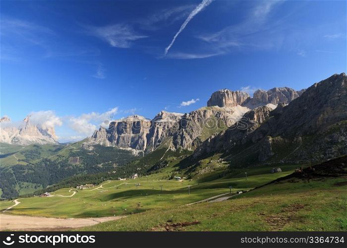 summer view of Italian Dolomites in Fassa Valley with Saas Pordoi and Sassolungo mountain