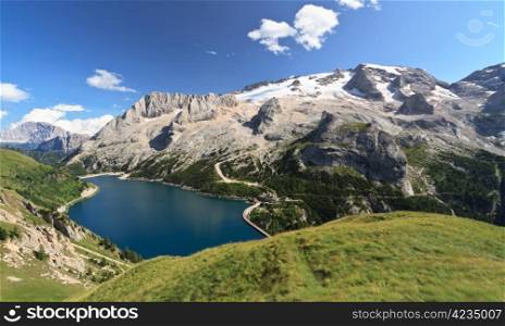summer view of mount Marmolada and Fedaia lake, Trentino, Italy