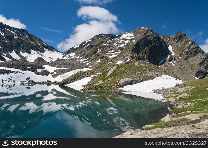 summer view of Red Stone Lake, Aosta valley, Italy