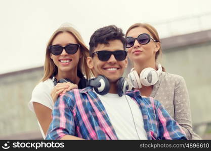 Summer weekend with friends. Three young happy people outdoors having good time