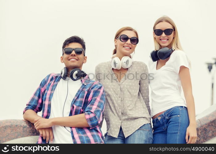 Summer weekend with friends. Three young happy people outdoors having good time