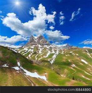 Summer Widderstein mountain sunshiny view with deep blue cloudy sky (Warth, Vorarlberg, Austria).