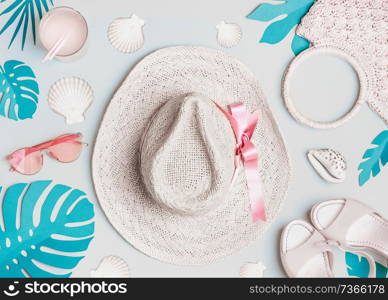 Summer woman accessories with shells and tropical leaves on pastel color background, top view. Straw hat, sunglasses, sandals and handbag. Holiday vacation. Female fashion outfit