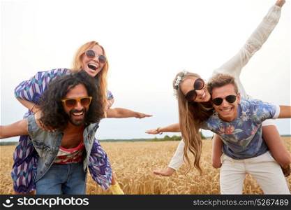 summer, youth culture and people concept - happy young hippie friends having fun on cereal field. happy hippie friends having fun on cereal field