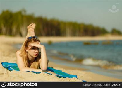 Summertime pleasures, enjoying vacation concept. Woman in bikini sunbathing and relaxing on beach. Woman in bikini sunbathing and relaxing on beach