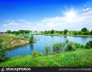 Sun and blue sky over the calm river