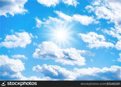Sun and clouds on blue sky. Sun with sun rays and clouds on blue sky as nature background