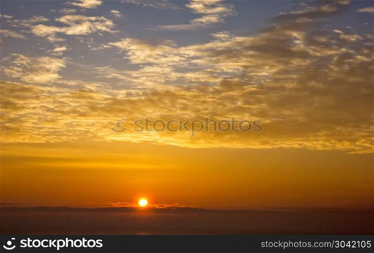 Sun ball. Amazing sunrise with beautiful clouds over the horizon