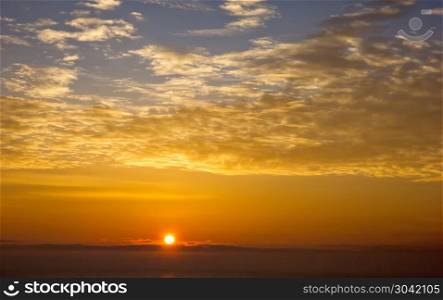 Sun ball. Amazing sunrise with beautiful clouds over the horizon