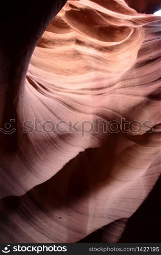 Sun beams glinting of the red rock walls of a slot canyon in Arizona.