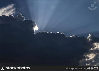 Sun Beams in Dark Clouds and Sky before Thunderstorm