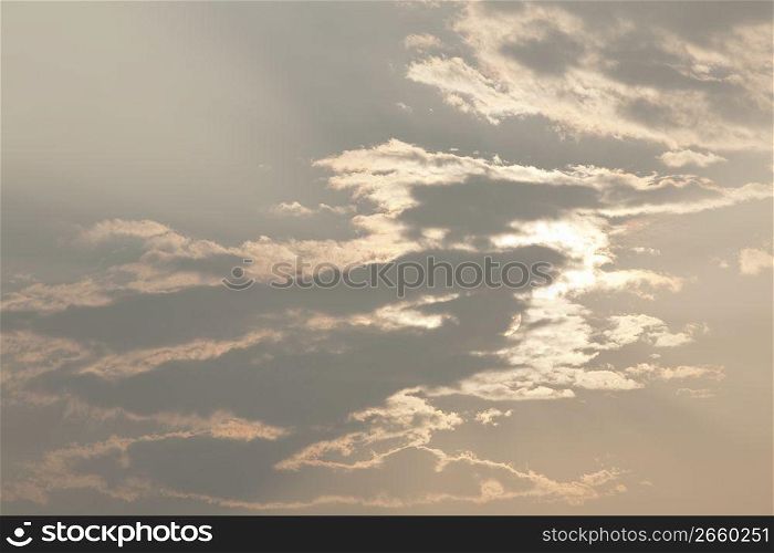 sun behind clouds