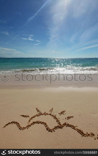 Sun drawing on a beach. Sun drawing on a beach of blue sea