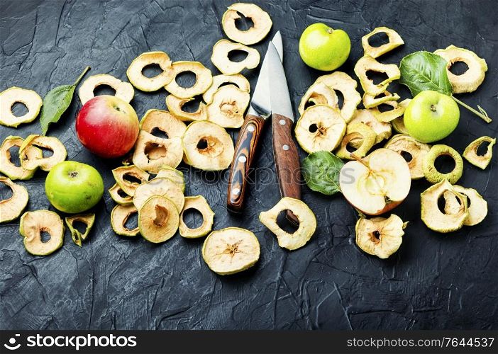 Sun-dried apple slices or apple chips and fresh apple.Homemade dried apple. Dried apple rings