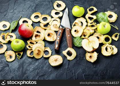 Sun-dried apple slices or apple chips and fresh apple.Homemade dried apple. Dried apple rings