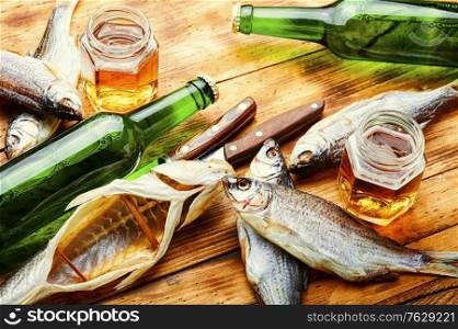 Sun dried fish,salted fish.Salty fish or stockfish.Glass of beer and dried fish. Sun dried fish