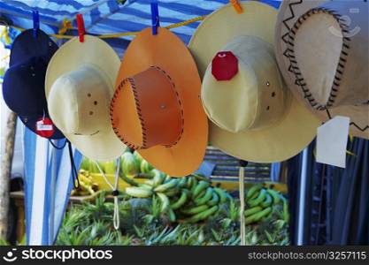 Sun hats hanging at a market stall, Puerto Rico