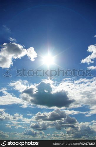 sun in a blue cloudy sky