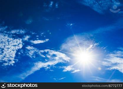 sun in a blue cloudy sky