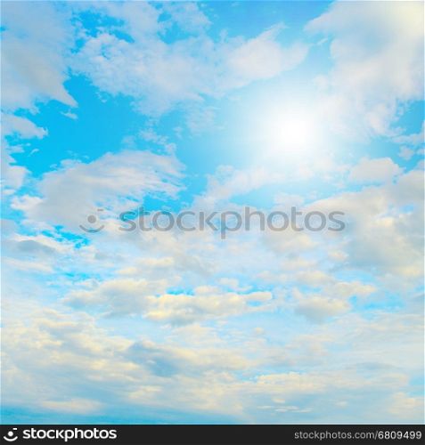 Sun in blue sky and white clouds. Heavenly landscape