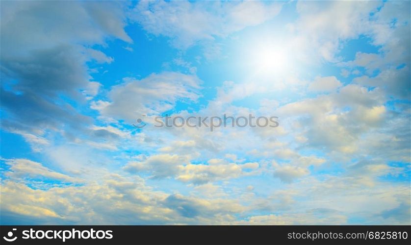 Sun in blue sky and white clouds. Heavenly landscape