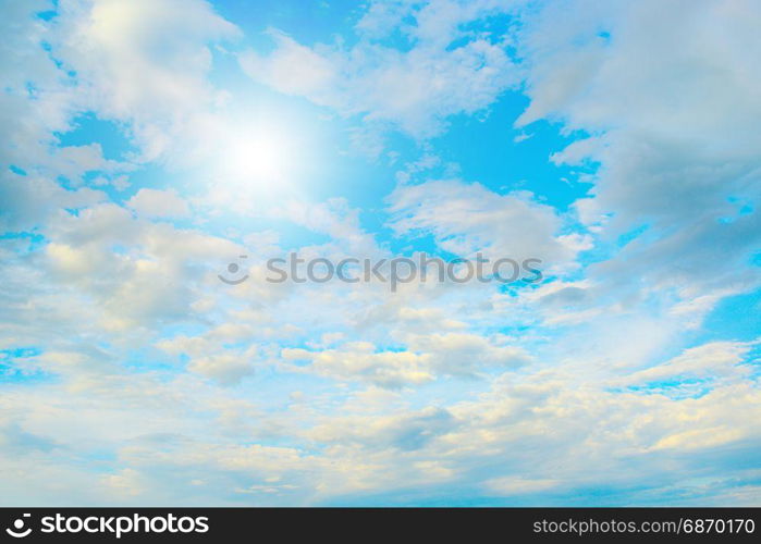 Sun in blue sky and white clouds. Heavenly landscape