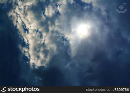 Sun in blue sky with clouds. Sun in blue dramatic sky with clouds