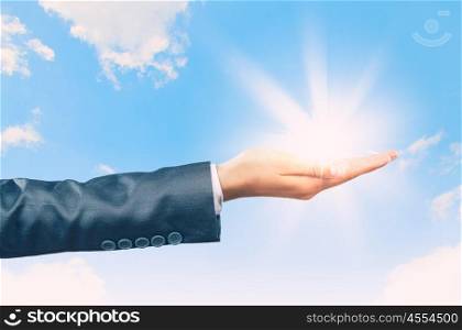 Sun in hand. Close up image businesswoman holding sun in palm
