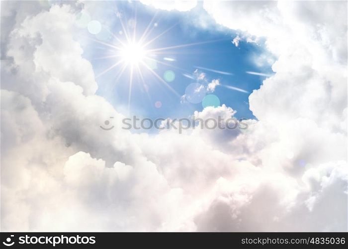 Sun in sky. Image of bright sun shining from behind clouds