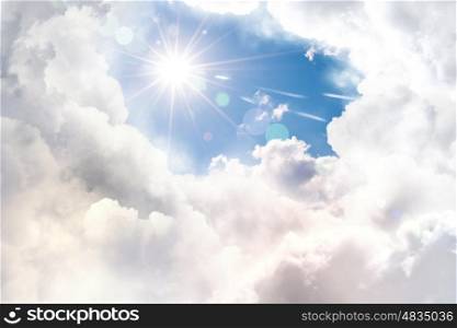 Sun in sky. Image of bright sun shining from behind clouds