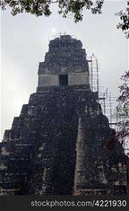 Sun, mist and old pyramid in Tikal, Guatemala