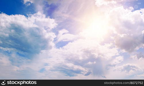 sun on blue sky with white clouds