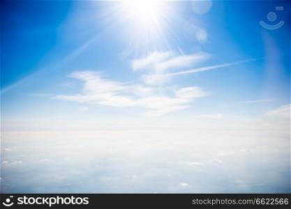 Sun on clear blue sky and beautiful white clouds