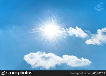 Sun on the blue sky. Sun with sun rays on the blue sky with clouds